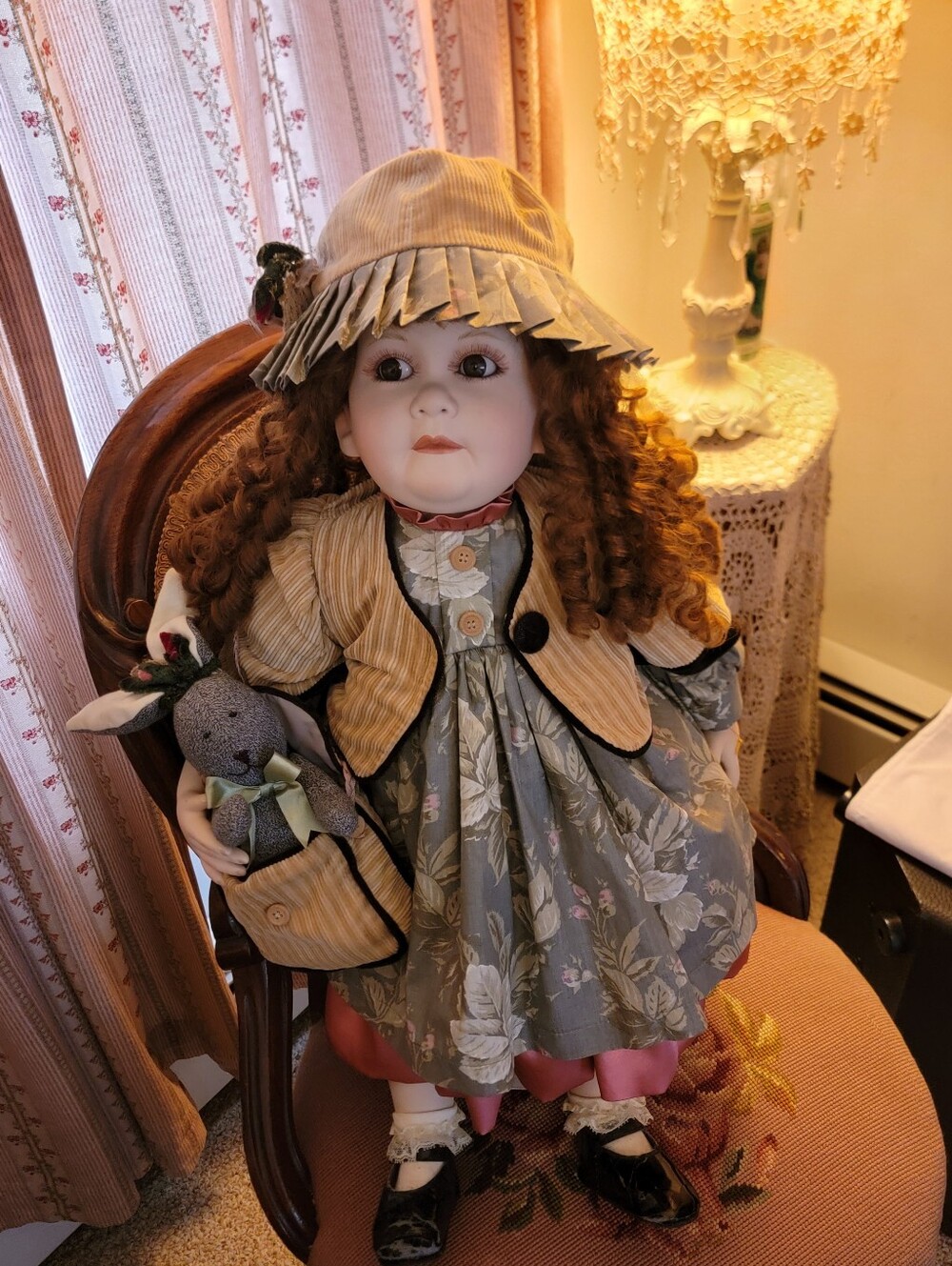 Porcelain Vintage Life Size Doll in Floral Green Dress with Tan Jacket and Hat.